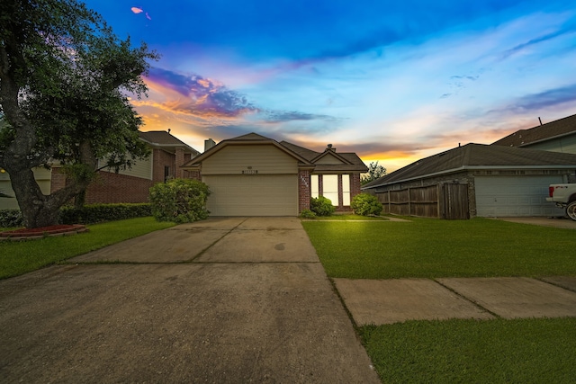 15153 Grassington Dr, Channelview, TX 77530 - view of front of house with brick siding, a front yard, an attached garage, and concrete driveway