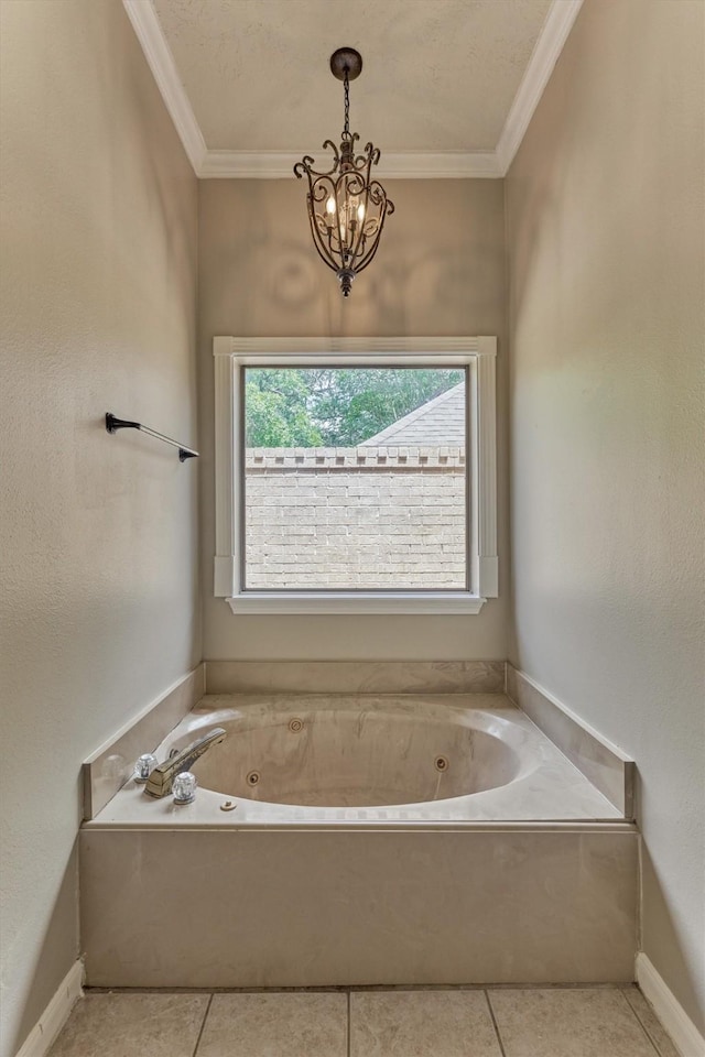 full bathroom with a jetted tub, ornamental molding, a chandelier, tile patterned floors, and baseboards