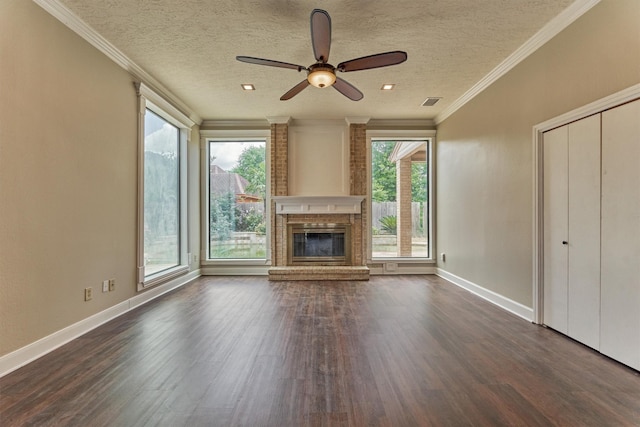 unfurnished living room with dark wood-style floors, a ceiling fan, baseboards, a textured ceiling, and ornamental molding
