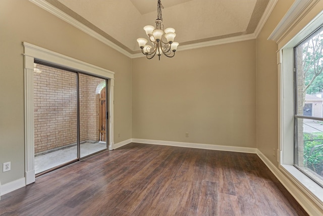 unfurnished room with a chandelier, healthy amount of natural light, dark wood-style flooring, baseboards, and crown molding