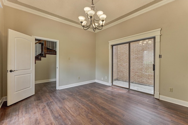 empty room with a chandelier, ornamental molding, dark wood-style flooring, stairway, and baseboards