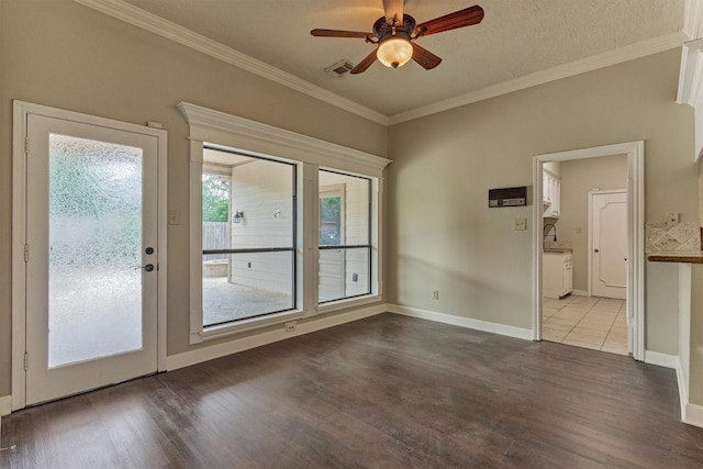 unfurnished room featuring ceiling fan, wood finished floors, crown molding, and baseboards