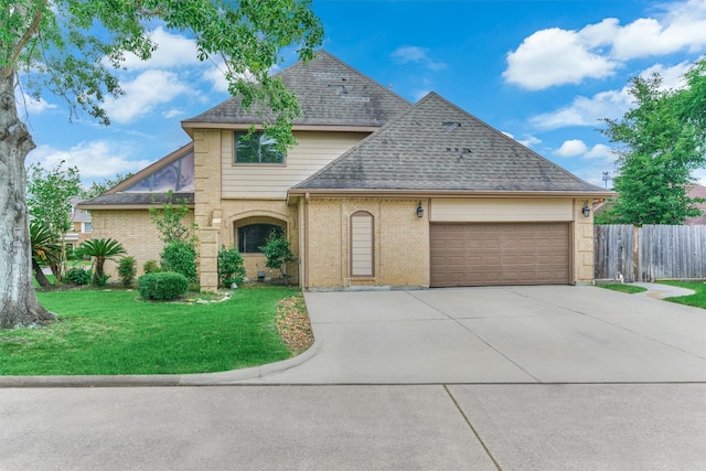 view of front of house featuring a garage, driveway, brick siding, and a shingled roof