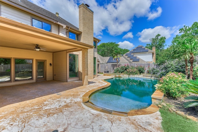 view of swimming pool with ceiling fan, a fenced backyard, and a patio area