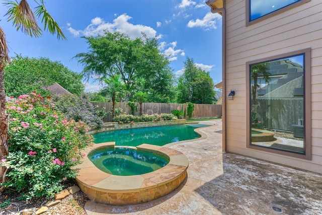 view of swimming pool with a fenced backyard, an in-ground hot tub, and a patio