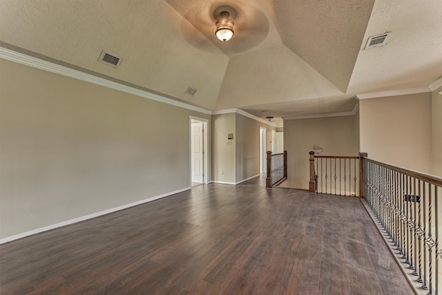 spare room with wood finished floors, a ceiling fan, a textured ceiling, vaulted ceiling, and baseboards