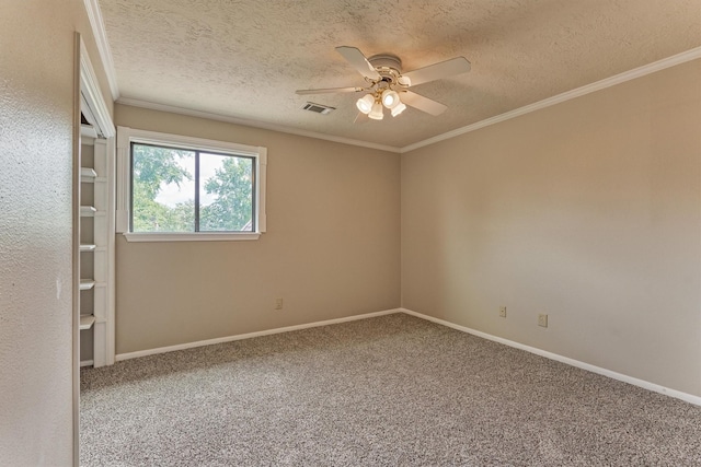 carpeted empty room with a textured ceiling, ceiling fan, crown molding, and baseboards