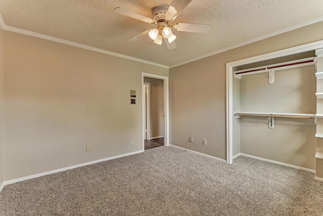 unfurnished bedroom with carpet, a textured ceiling, a closet, a ceiling fan, and crown molding