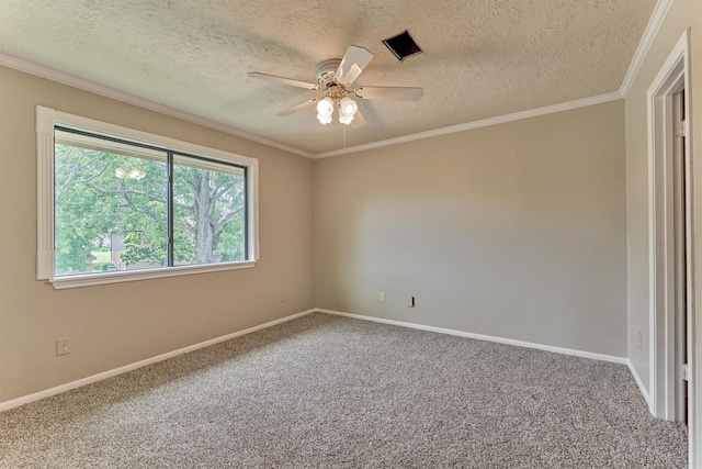 carpeted spare room with ceiling fan, a textured ceiling, baseboards, and ornamental molding