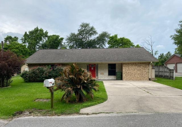 404 Friery St, Dayton, TX 77535 - ranch-style house featuring a front yard and concrete driveway