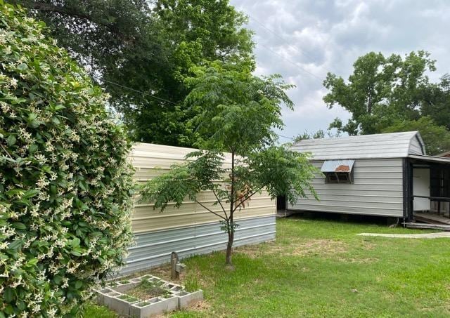 404 Friery St, Dayton, TX 77535 - view of side of property with a lawn