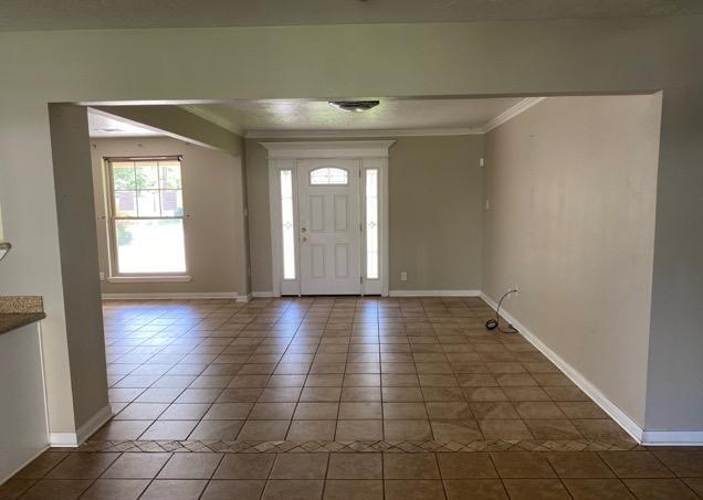 404 Friery St, Dayton, TX 77535 - foyer featuring tile patterned flooring, baseboards, and crown molding