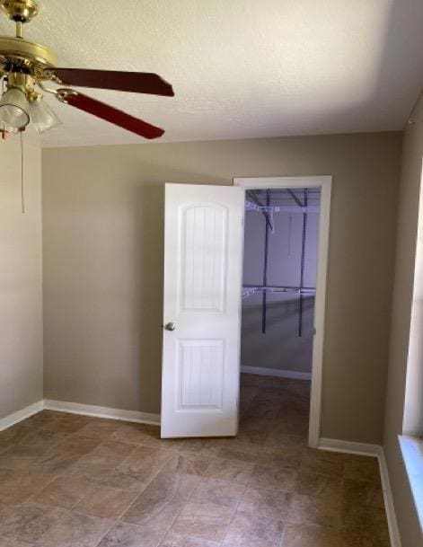 404 Friery St, Dayton, TX 77535 - unfurnished room featuring ceiling fan and baseboards