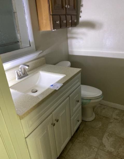 404 Friery St, Dayton, TX 77535 - bathroom with vanity, toilet, and tile patterned floors