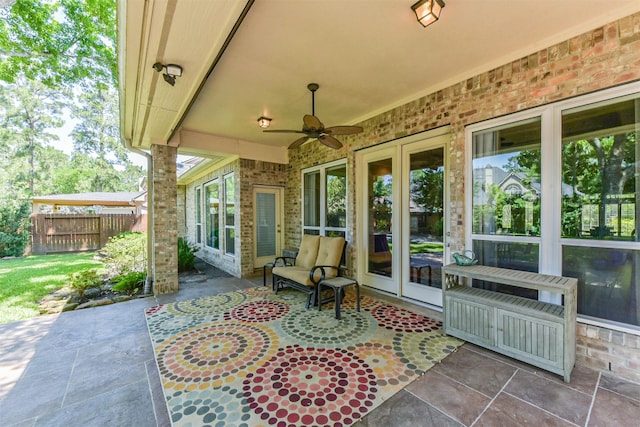 view of patio / terrace featuring fence and ceiling fan