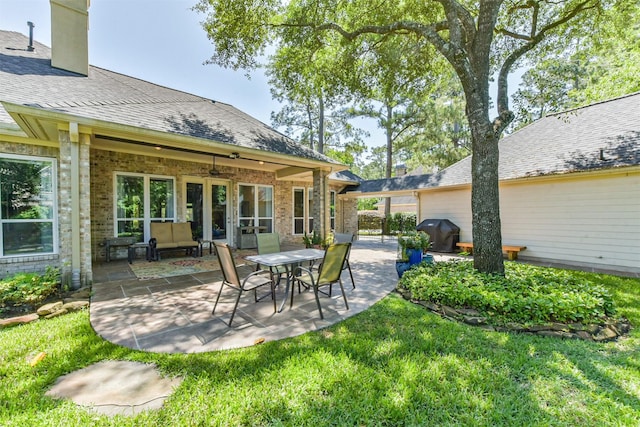 view of patio featuring ceiling fan and a grill