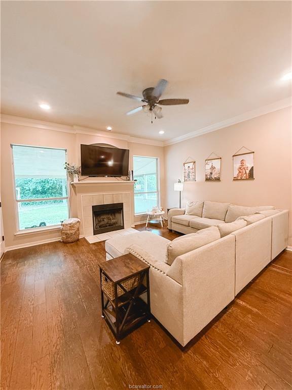 52 Fairway Dr, Normangee, TX 77871 - living area featuring ornamental molding, hardwood / wood-style flooring, a ceiling fan, a fireplace, and baseboards