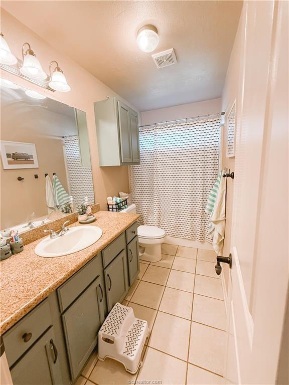 52 Fairway Dr, Normangee, TX 77871 - full bath with tile patterned flooring, vanity, and toilet