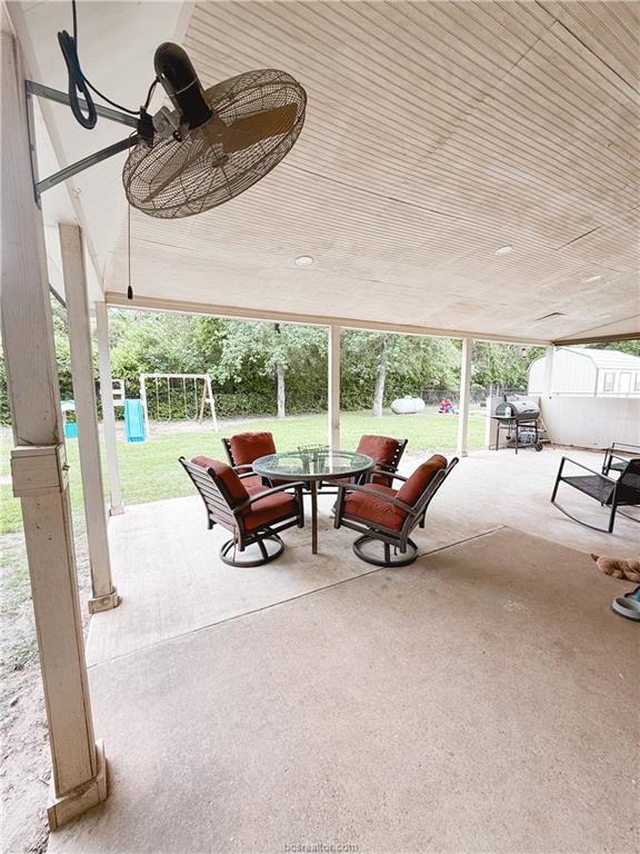 52 Fairway Dr, Normangee, TX 77871 - view of patio with outdoor dining space, a playground, a shed, an outdoor structure, and grilling area
