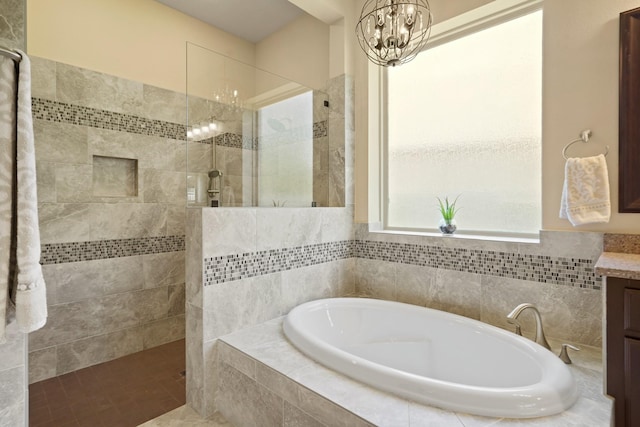 146 Painted Trillium Dr, Conroe, TX 77304 - bathroom featuring a chandelier, a bath, walk in shower, and vanity