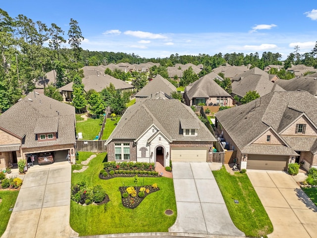 146 Painted Trillium Dr, Conroe, TX 77304 - view of front of house featuring brick siding, concrete driveway, a residential view, and stone siding