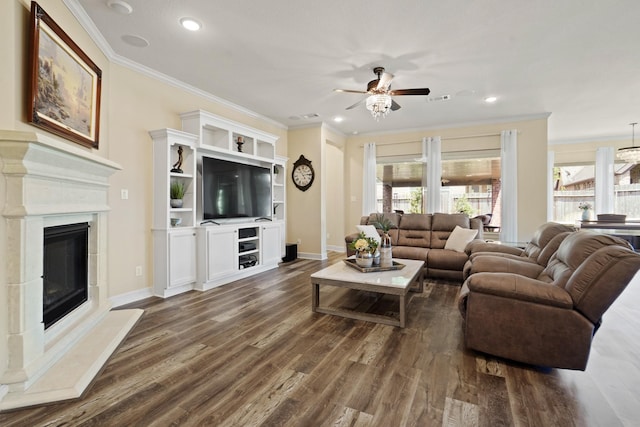 146 Painted Trillium Dr, Conroe, TX 77304 - living area with ornamental molding, ceiling fan, plenty of natural light, a glass covered fireplace, and dark wood-style floors