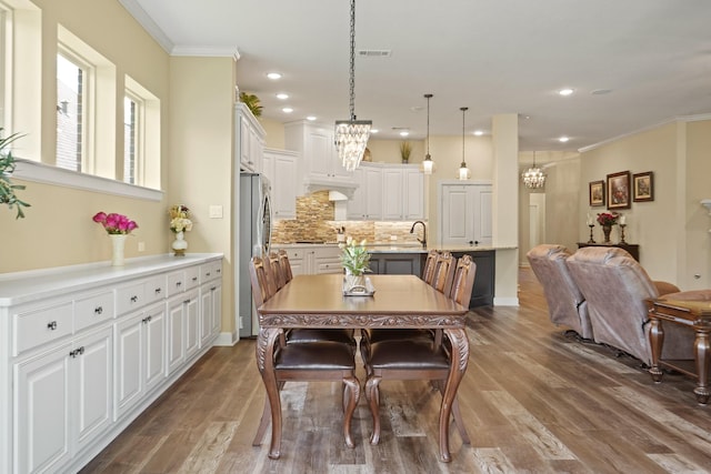 146 Painted Trillium Dr, Conroe, TX 77304 - dining room featuring a chandelier, wood finished floors, crown molding, and recessed lighting
