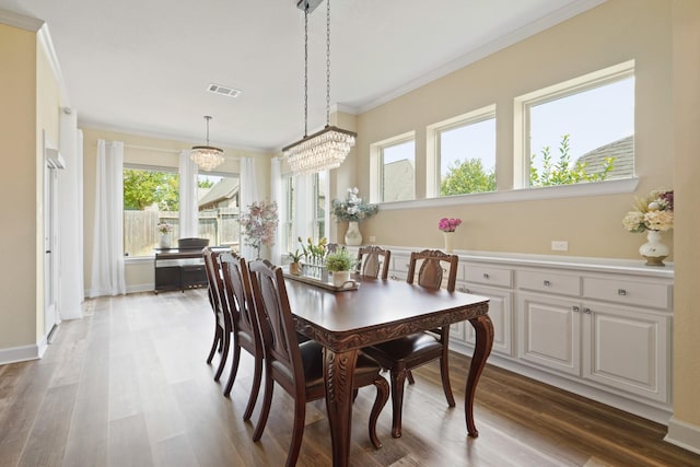 146 Painted Trillium Dr, Conroe, TX 77304 - dining room featuring ornamental molding, wood finished floors, and a chandelier