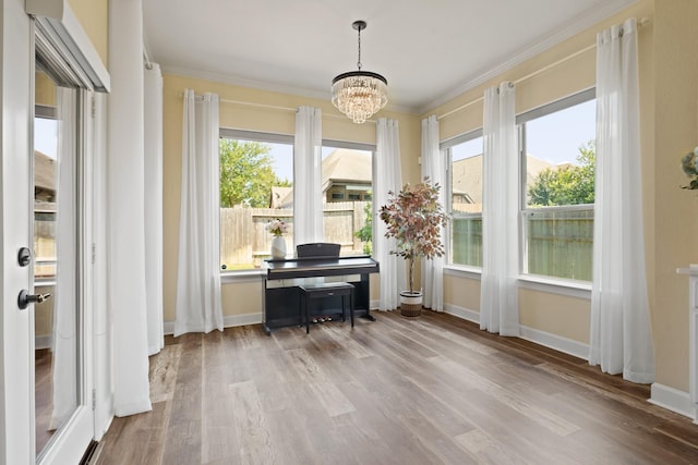 146 Painted Trillium Dr, Conroe, TX 77304 - office area featuring a chandelier, crown molding, wood finished floors, and baseboards