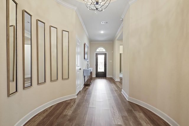 146 Painted Trillium Dr, Conroe, TX 77304 - doorway with ornamental molding, dark wood finished floors, a chandelier, and baseboards