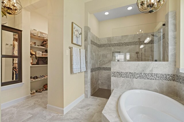 146 Painted Trillium Dr, Conroe, TX 77304 - full bath featuring a chandelier, a walk in shower, a bath, and a walk in closet