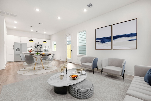 747 Dumble St, Houston, TX 77023 - living room featuring light wood-style floors, recessed lighting, and baseboards