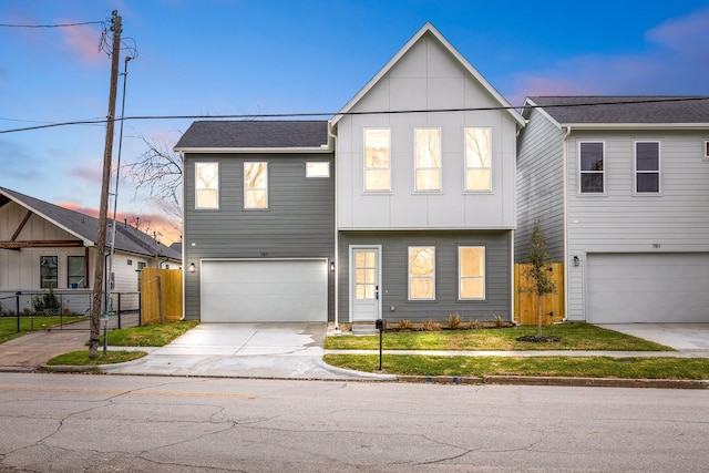747 Dumble St, Houston, TX 77023 - view of front facade with an attached garage, board and batten siding, driveway, and roof with shingles