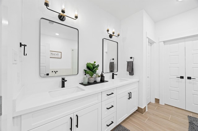 5814 Highland Sky Ln, Houston, TX 77091 - full bath with double vanity, wood finished floors, and recessed lighting
