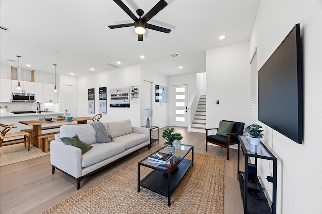 5814 Highland Sky Ln, Houston, TX 77091 - living area featuring ceiling fan, light wood finished floors, stairway, and recessed lighting