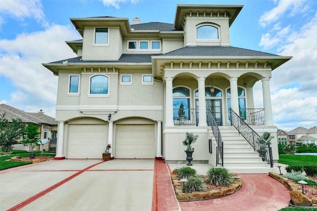 12590 St Ann Ct, Willis, TX 77318 - view of front facade featuring stucco siding, driveway, a porch, an attached garage, and stairway