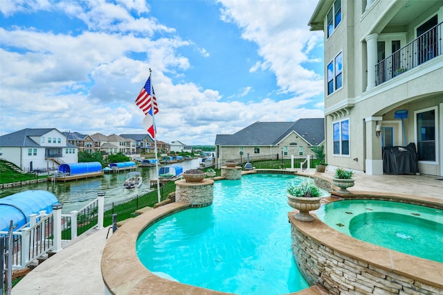 12590 St Ann Ct, Willis, TX 77318 - view of swimming pool with a pool with connected hot tub, a residential view, a patio area, and fence