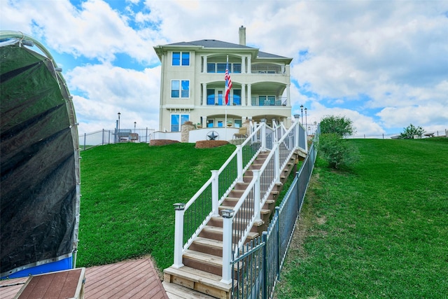 12590 St Ann Ct, Willis, TX 77318 - rear view of house featuring a balcony, stairs, and a chimney