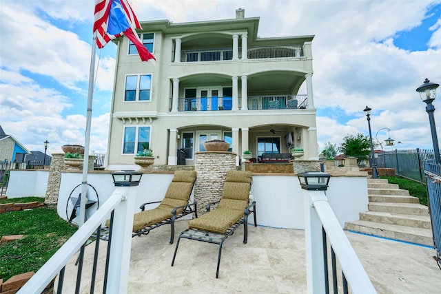 12590 St Ann Ct, Willis, TX 77318 - back of house with a balcony, fence, and a patio area