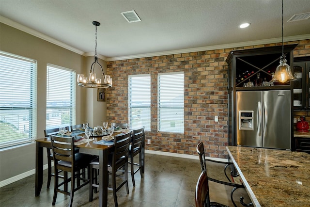12590 St Ann Ct, Willis, TX 77318 - dining room with baseboards, ornamental molding, a chandelier, brick wall, and a textured ceiling