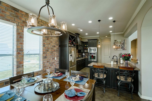 12590 St Ann Ct, Willis, TX 77318 - dining space with a chandelier, brick wall, recessed lighting, and ornamental molding