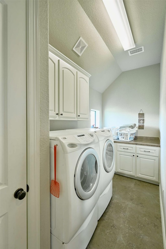 12590 St Ann Ct, Willis, TX 77318 - laundry room featuring separate washer and dryer, cabinet space, and a textured ceiling