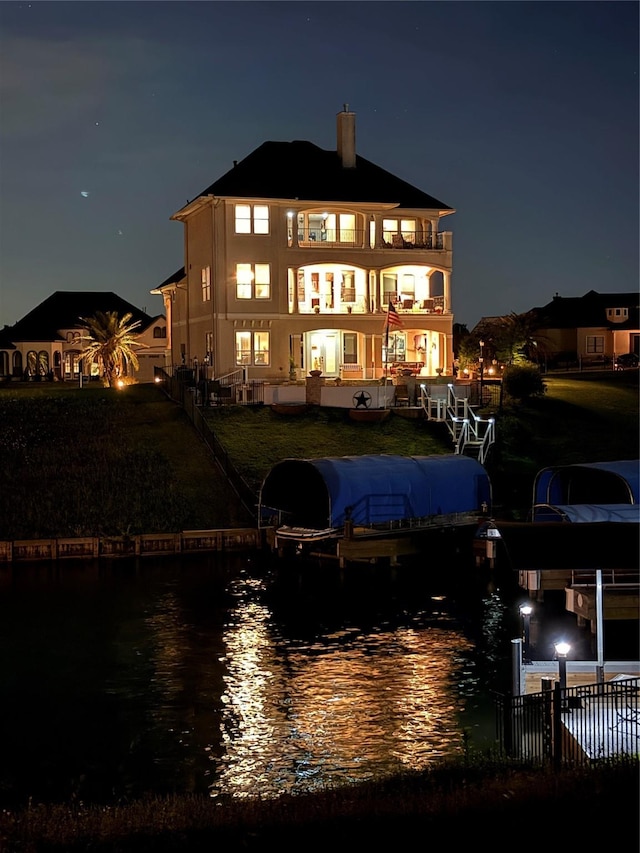 12590 St Ann Ct, Willis, TX 77318 - property at night with a water view and fence