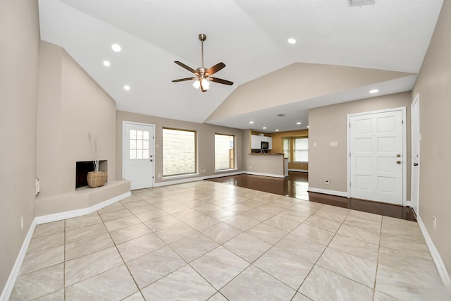 2026 Hickory Glen Dr, Missouri City, TX 77489 - unfurnished living room with vaulted ceiling, ceiling fan, recessed lighting, baseboards, and light tile patterned floors