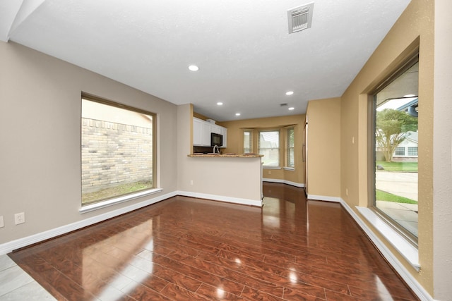 2026 Hickory Glen Dr, Missouri City, TX 77489 - unfurnished living room with dark wood finished floors, baseboards, and recessed lighting