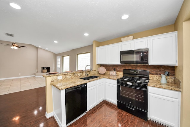 2026 Hickory Glen Dr, Missouri City, TX 77489 - kitchen with black appliances, a sink, a peninsula, tasteful backsplash, and recessed lighting
