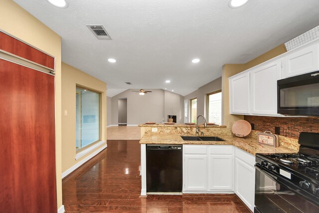 2026 Hickory Glen Dr, Missouri City, TX 77489 - kitchen with black appliances, a sink, a peninsula, light stone countertops, and recessed lighting