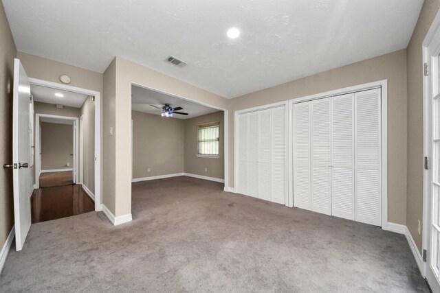 2026 Hickory Glen Dr, Missouri City, TX 77489 - unfurnished bedroom featuring carpet, baseboards, two closets, and a ceiling fan