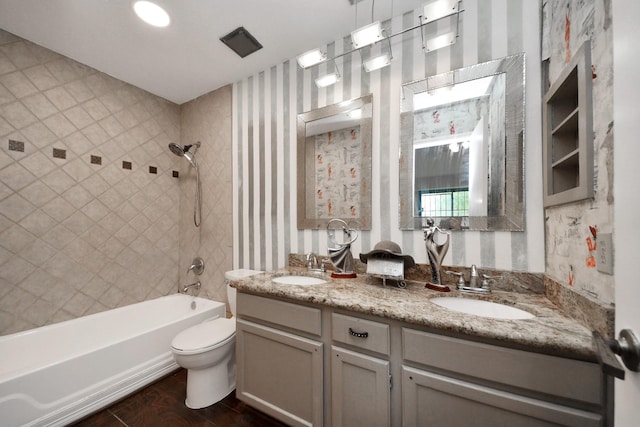 2026 Hickory Glen Dr, Missouri City, TX 77489 - bathroom with double vanity, shower / washtub combination, toilet, wallpapered walls, and wood finished floors