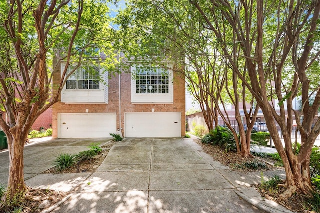 1202 Marconi St, Houston, TX 77019 - view of front of property with a garage, concrete driveway, and brick siding
